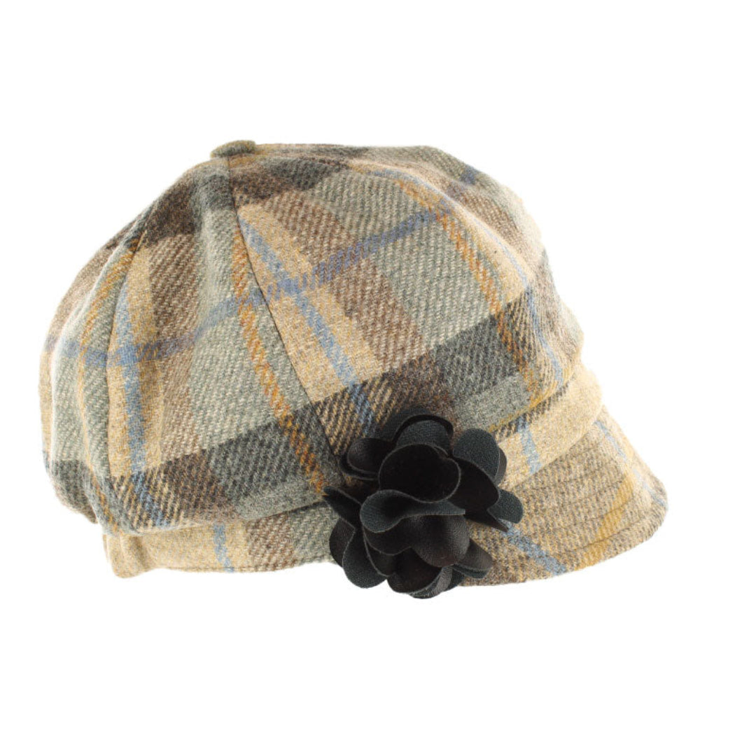 Plaid patterned hat with a black flower on a white background